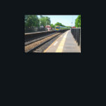 Deighton Railway Station, Huddersfield Leinwanddruck<br><div class="desc">This dynamic photo captures a TransPennine Express train as it speeds through Deighton Railway Station in West Yorkshire. The clear blue sky and lush green trees highlight the classic British railway scene, making it a perfect piece for trainspotters, commuters, and lovers of UK transport. A fantastic addition to any product,...</div>