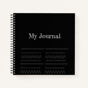 Dekorationsdruck auf einem schwarzen Spiralheft Notizblock