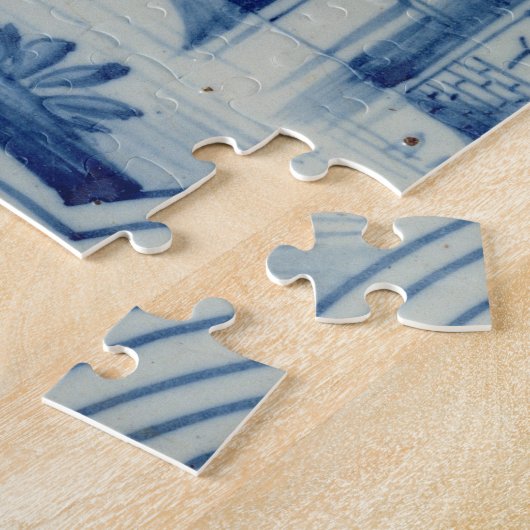 Delft-Fliese, die einen Drawbridge über einem Puzzle (Seite)