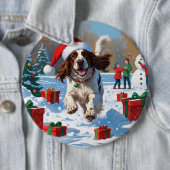 Der englische Setter läuft im Schnee mit Weihnacht Button (Beispiel)