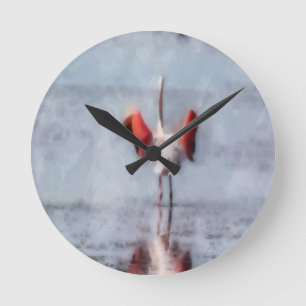 Der rosa Flamingo in der Wasserfarbe Runde Wanduhr