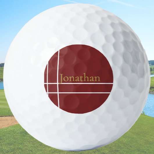 Der schlichte, dunkelrote und goldene individuelle golfball