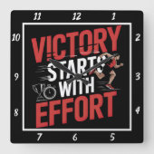 Der Sieg beginnt mit dem Anstrenger Quadratische Wanduhr (Vorderseite)
