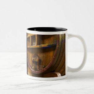 Der Weinkellerkeller mit großen alten Holzfässern Zweifarbige Tasse