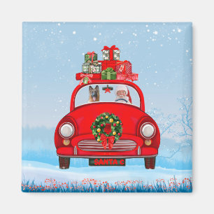 Deutscher Schäferhund im Auto mit dem Weihnachtsma Magnet