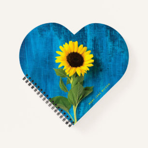 Dicke gelbe Sonnenblume auf blau Notizblock