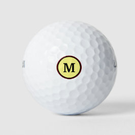 Dicke Monogramm in zwei Kreisen und gelber Hinterg Golfball