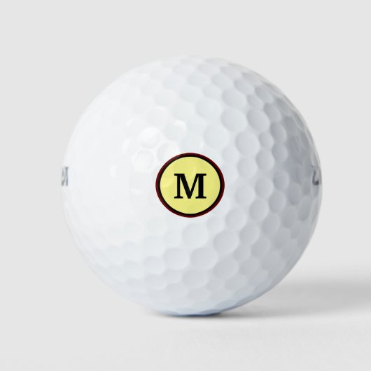 Dicke Monogramm in zwei Kreisen und gelber Hinterg Golfball (Vorderseite)