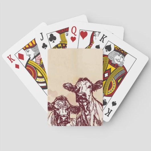 Die Hand mit zwei Kühen zeichnen die Skizze u. Spielkarten (Rückseite)