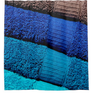 Die Handtücher sind blau, türkisblau und grau Duschvorhang