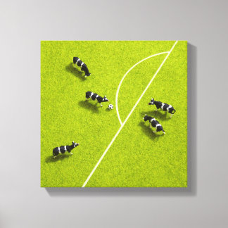 Die Kühe, die Fußball spielen Leinwanddruck