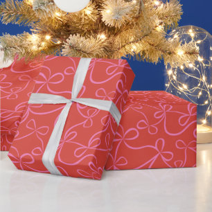 Die rosa Ribbon Bogen auf der roten Moderne Urlaub Geschenkpapier