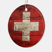 Die Schweiz-Flagge auf altem hölzernem Korn Keramikornament (Links)