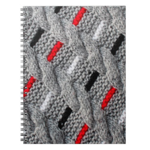 die Textur des Strickstoffes mit gestreiftem p Notizblock
