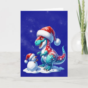 Dinosaur mit Weihnachtsmannmütze baut einen Schnee Feiertagskarte