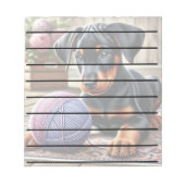 Doberman Puppy mit Garnball auf einem farbenfrohen Notizblock (Vorderseite)