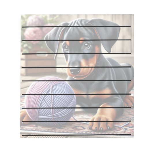 Doberman Puppy mit Garnball auf einem farbenfrohen Notizblock (Vorderseite)