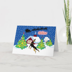 Dobermann glauben an Sankt-Weihnachten Feiertagskarte