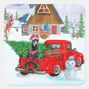 Dobermann-Hund im Weihnachtslieferwagen Schnee Quadratischer Aufkleber