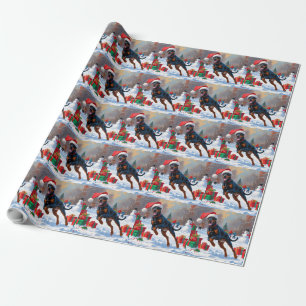 Dobermann läuft im Schnee mit Weihnachtsmütze Geschenkpapier