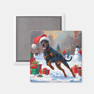 Dobermann läuft im Schnee mit Weihnachtsmütze Magnet