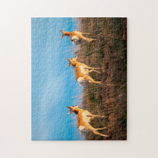 Drei Antilopen, die bei Sonnenuntergang weglaufen Puzzle (Vertikal)