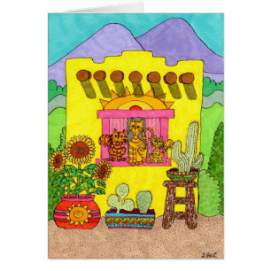 Drei Katzen in einem gelben Adobe-Haus