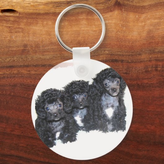 Drei schwarz-silberne Spielzeugpuppen Schlüsselanhänger (Vorderseite)