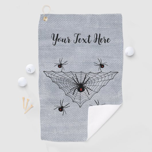 Dreieckiges Netz mit schwarzen Witwerspinnen auf W Golfhandtuch (Insitu)