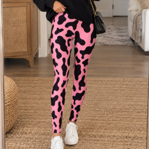Druck von schwarzen Kühen auf rosa Hintergrund Leggings