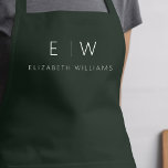 Dunkelgrünes Elegant Moderner Minimalistischer Mon Schürze<br><div class="desc">Erleben Sie kulinarische Erlebnisse mit unserer klassischen Elegant Moderne Minimalistische Monogram Name Cooking Schürze. Diese Küche ist unverzichtbar und vereint zeitlose Eleganz mit zeitgemäßem Minimalismus. Diese Schürze ist nicht nur ein praktisches Accessoire, sondern auch eine persönliche Note. Mit der individuell anpassbaren Monogramm- und Namensoption können Sie Ihre Persönlichkeit in Ihre...</div>