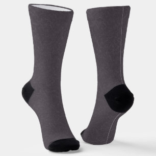 Dunkle violette texturierte Oberfläche mit wirbeln Socken