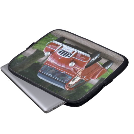 Ein altes, rotes Citroen 2CV Auto mit einer lächel Laptopschutzhülle (Vorne Knopf)