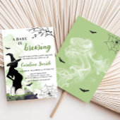 Ein Baby brütet eine grüne Hexenzittel-Babydusche Einladung