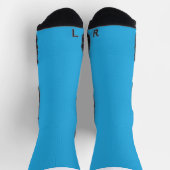 ein blauer Hintergrund mit einer schwarz-weißen Ka Socken (Oben)