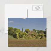 Ein gezüchtetes Feld vor Strohdächern Postkarte (Vorne/Hinten)
