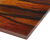 Ein glänzender orangefarbener Sonnenuntergang, dur Schneidebrett (Ecke)