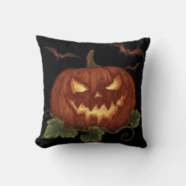 Ein großer Kürbis mit leuchtenden Augen und Fleder Kissen