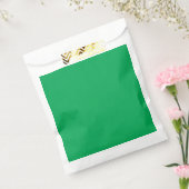 ein grüner Hintergrund mit Geschenktütchen (Versiegelt)