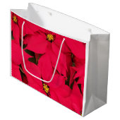 Ein Haufen farbenfroher Weihnachtspoinsettias Große Geschenktüte (Vorderseite Schrägansicht)