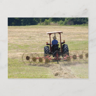 Ein junger Junge fährt einen Traktor zur Ernte Postkarte
