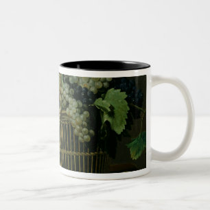 Ein Korb der Trauben Zweifarbige Tasse
