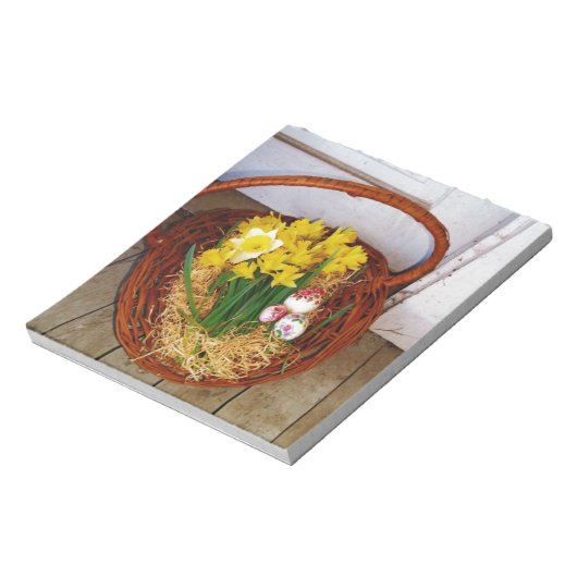 Ein Körbchen mit gelben Eizellen und blumengeschmü Notizblock (Rotiert)