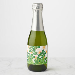 Ein künstlerisches Muster in Grün und Gold, das ei Schaumweinetikett