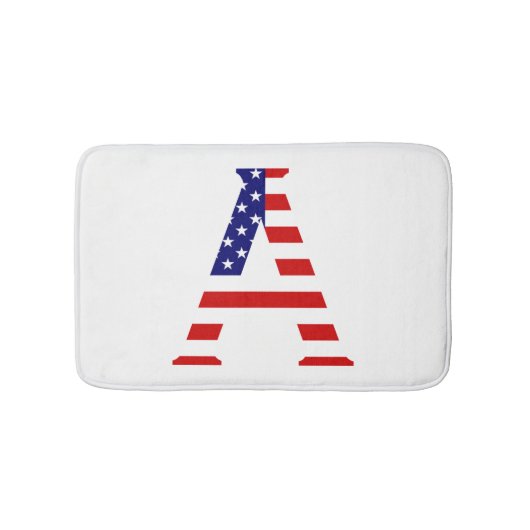 Ein Monogramm überlagert sich auf dem Flag-Feld de Badematte (Vorderseite)