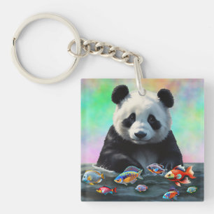Ein Panda schaut neugierig auf schwimmende bunte F Schlüsselanhänger