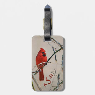 Ein roter Kardinals-Vogel auf einer Niederlassung Gepäckanhänger