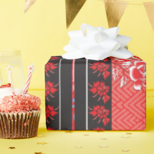 ein rotes und schwarzes Muster mit Blume darauf Geschenkpapier