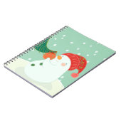 Ein Schneemann, der eine Verzierung auf einem Baum Notizblock (Linke Seite)