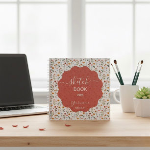 Ein Skizzenbuch mit floralen Designs Notizblock